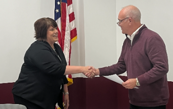 Emily Klocko shaking James Rossler hand.