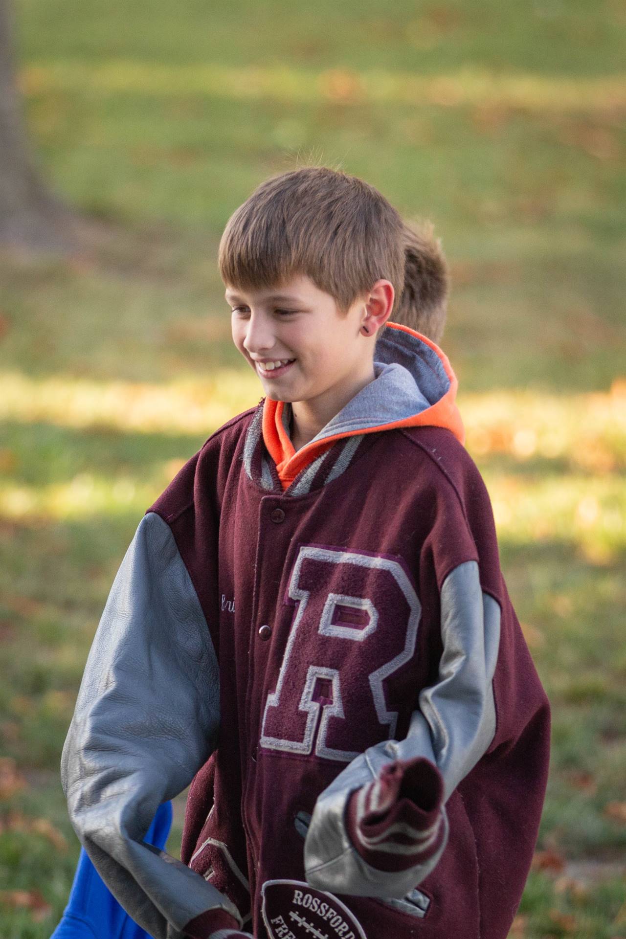 Rossford Alumni Tailgate - child wearing family varsity jacket.