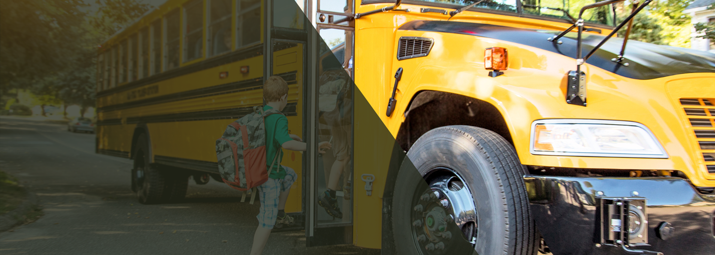 Child getting on a school bus.