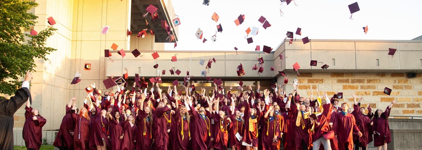 RHS Class of 2024 throwing their hats in the air.