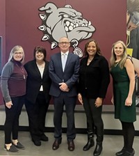 Board of Education standing together.